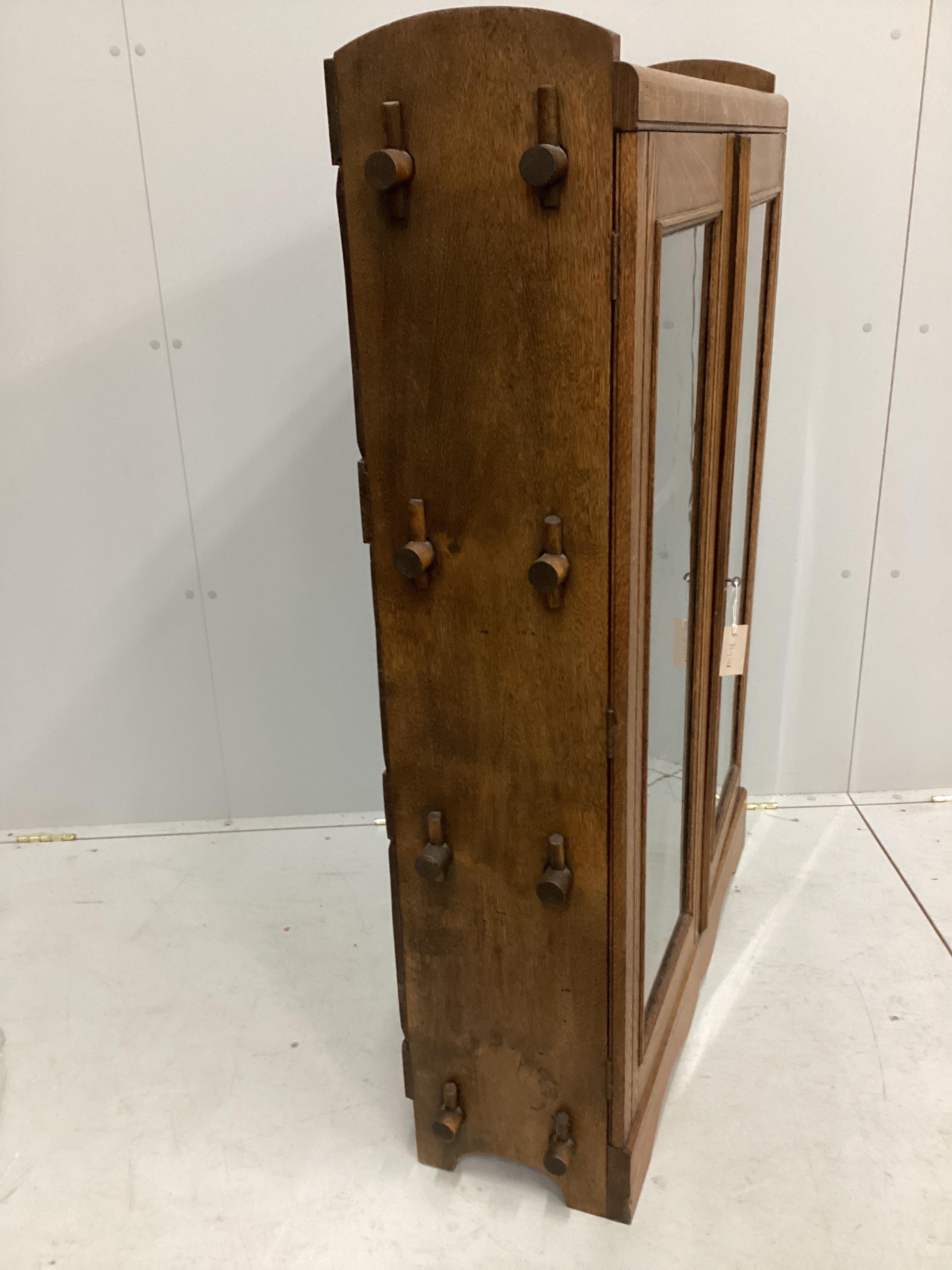 A Cotswold style glazed oak two door bookcase, width 90cm, depth 27cm, height 130cm